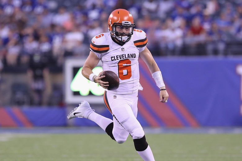 Baker Mayfield carries the football.